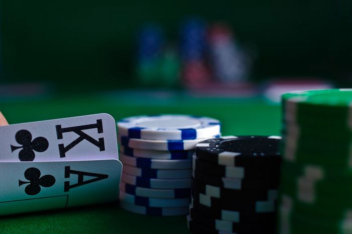“Poker player looks at their cards”